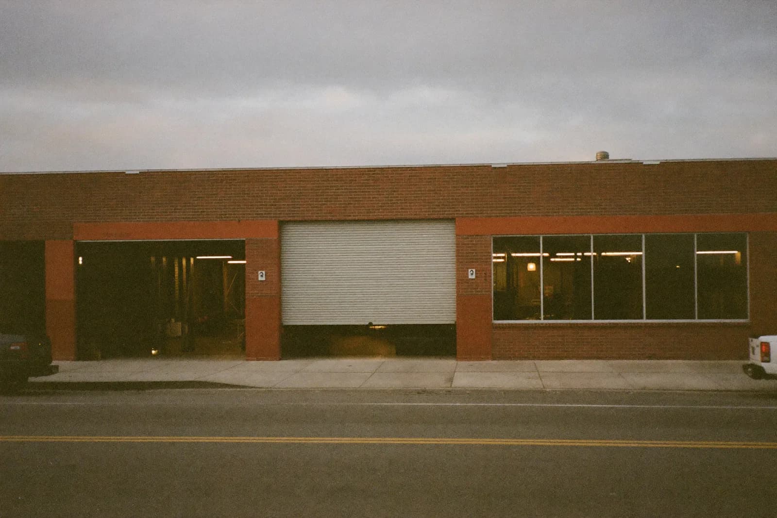 A small workshop occupying a former shopfront, machinery visible through the display window.